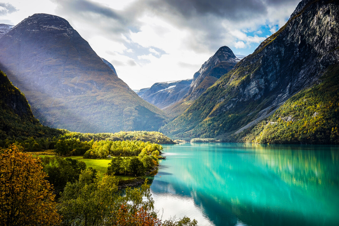 Clouds and sun beams over fjord